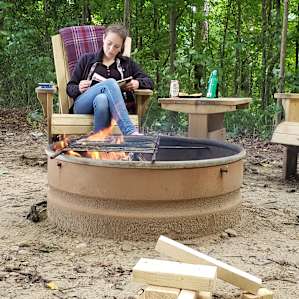 Quiet reading by an afternoon fire in the ultra-comfortable Adirondack chairs that John built himself! Notice the conveniently provided grill that makes cooking a breeze.