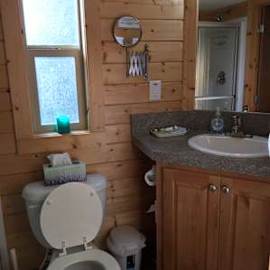 Clean and fairly spacious bathroom with a full-sized shower
