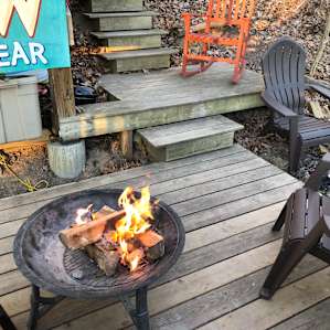 Fire pit is on the deck overlooking the river