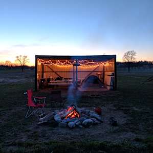 Watching beautiful sunset across the field. Getting ready for a cold night with a fire.