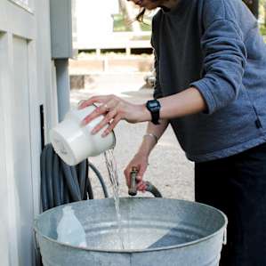 Dishes made easy with a hose, tub and dish soap.
