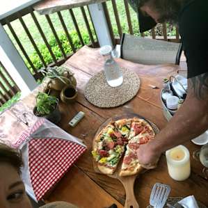 Homemade brick oven pizza, served on the porch