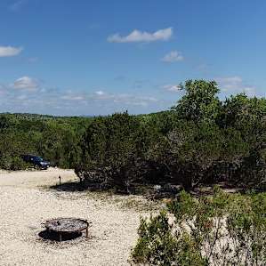 Big firepit for all to use below the outdoor communal dining area