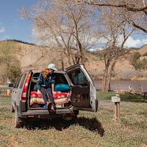 Pleased with my nice flat parking spot and power hookup at this RV spot along the river!