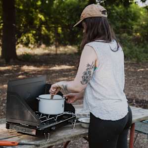 The campsite has a nice big picnic table, a lighter for your stove or fire, and a hose nearby for rinsing off.