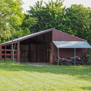 There's a portable toilet tucked in the back of this shed behind a wall.