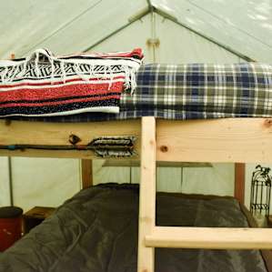 Inside the tent, there is a set of large bunk-beds. Pillows and blankets can be borrowed from Steve.