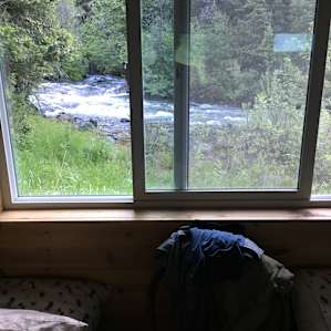 Cabin on bank of mountain stream
