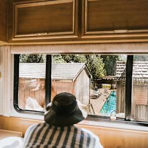 In the back of the RV is the double sized bed with a view of the pool.