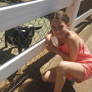 Happy kid with Tuxedo the goat