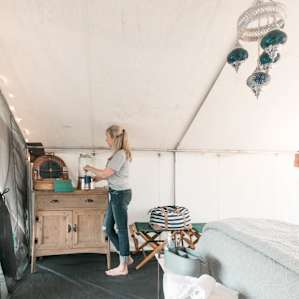 The tent is stocked with everything you could need, including a full picnic set and plenty of fresh water