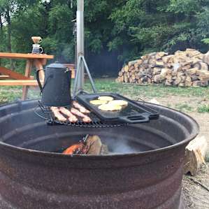 Breakfast over the fire. The coffee pot is ours.