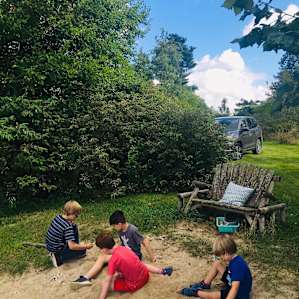 Kids enjoying the sand area by the pond