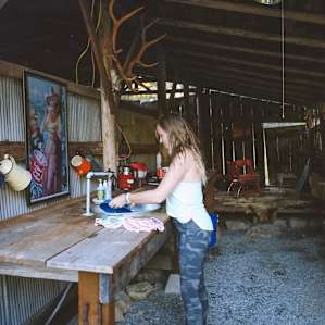 Washing dishes in the adorable barn near the tent