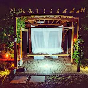 The pergola bed lit by solar lights.