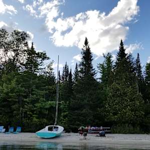 View of the beach from the water. We used the red picnic table but the chairs were not available for use.