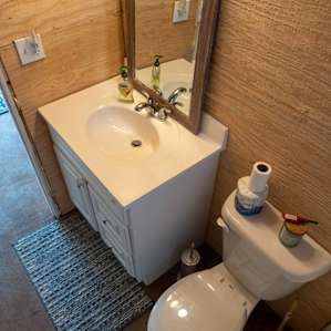 Toilet and sink in full bath.