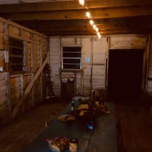 The camp kitchen barn at night. The site is well lit with solar lights.