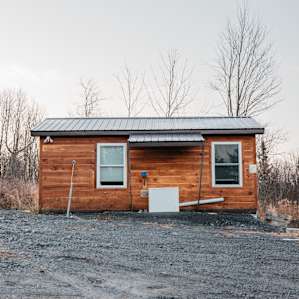 The lone cabin on the right side of the driveway.