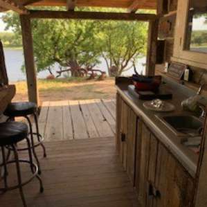 Outdoor kitchen with sink and stove! Handy! I cooked my dinner on the wood smoker - perfect combo