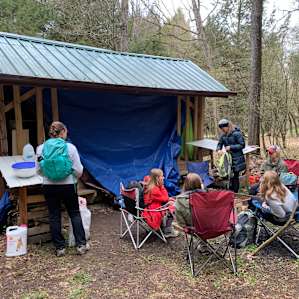 The tarp was easy to hang with bungees. We brought camp chairs. One chair was provided.
