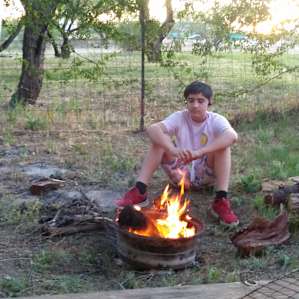 My son building a small fire in the fire pit.