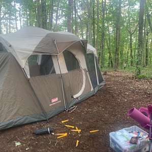 Old cabin in middle of campsite.