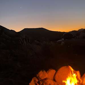 staying warm by the fire at dusk
