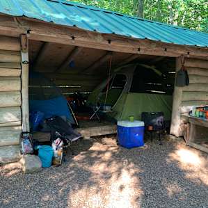 Shelter with tents set up inside.