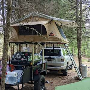 Our set up. We backed the trailer into the site and the truck is pointed in the direction of the entrance. The pond is off to the right, trees lined up that obscures the view of the large open field to the left.