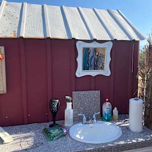 Bathroom sink area, soap, paper towels and toilet paper are provided and kept well stocked