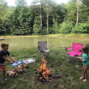 Our dog loved swimming in the pond while we gathered around the 🔥