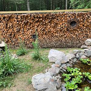 Beautifully stacked firewood and a man made creek