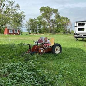 Our youngest exploring the farm. Great out of the way location between one of the barns and the chicken coop.