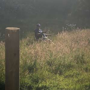 my husband enjoying a cigar in the middle of the field so that I didn't have to smell it haha