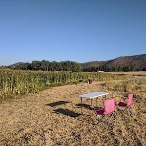 Campsite 1 lake side with chairs, table and bbq provided (cold outdoor shower and toilet a short walk away). The grass here is very fragrant and there's a beautiful view. It does get hot so bring hats.