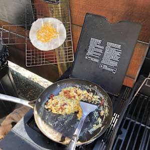 Making breakfast on the grill’s stove burner
