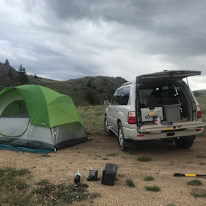 tent on the flat spot, vehicle parked to stop the wind and rain
