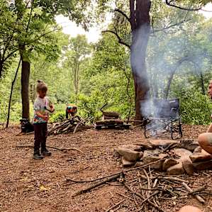 Large fire pit surrounded by plenty of firewood