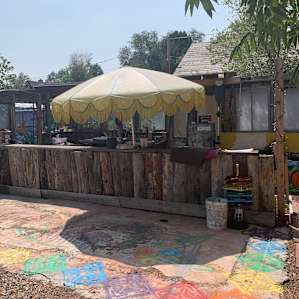 This is the hangout area with benches chair and table on the other side of the wall. Also the kitchen.