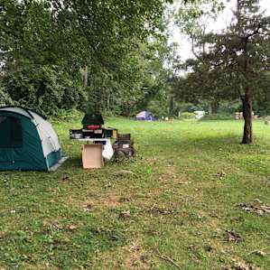 view of the separate parking area in the distance and another camper at site 6. There is an empty site 5 between us