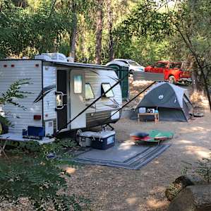Our 19' trailer, that took some master maneuvering, one (of four) tents, and three (of four) cars (parked in the driveway).
