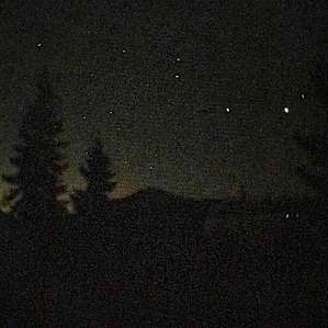 Gorgeous views of stars, trees and hills against the sunset
