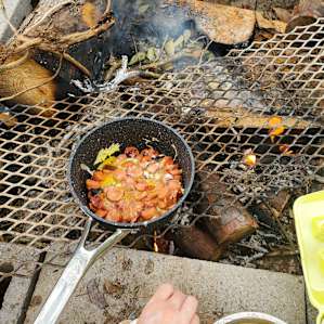 Using campfire as a grill also. Grill mesh and firewood available at camp, bring your own pans.