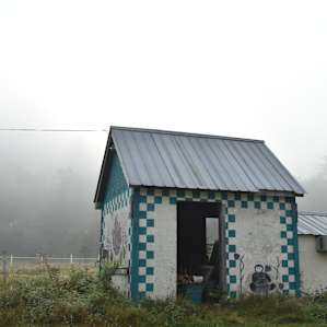 A farm outbuilding along the road next to the field where you camp