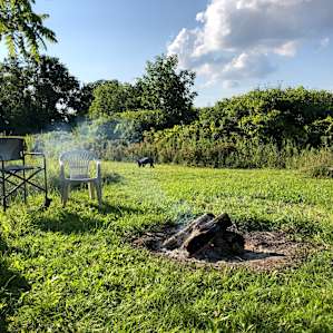 Large, private space with a fire pit and lots of wood