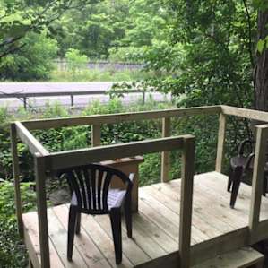i found this at the very entry of their driveway, there's a secret little patio. relax, enjoy the bubbling brook, the lull of passing cars, and wave at the twice daily train! cars are minimal, after dark. just you, and nature!