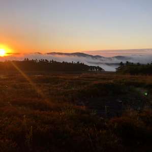 Clouds rolling through the hills at sunrise.
