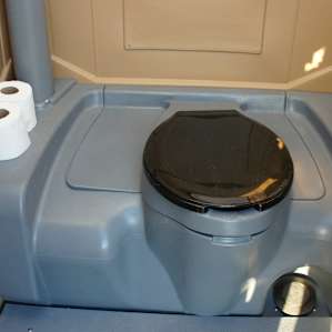 A very clean porta-john that flushes! Just step on the foot pedal.