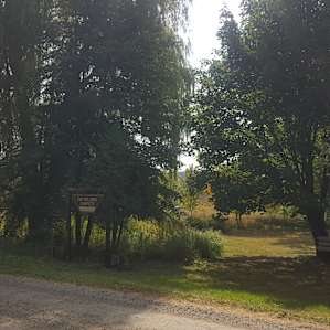 View of the campsite sign from the road. Look for the big willow tree and you know you're there!